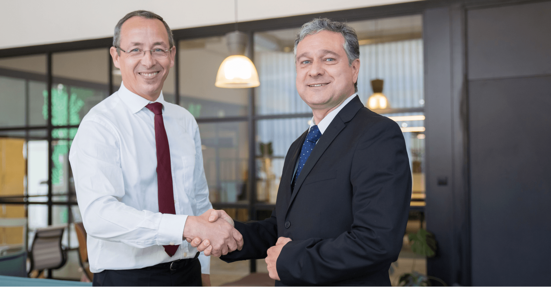 Two people shaking hands in an office